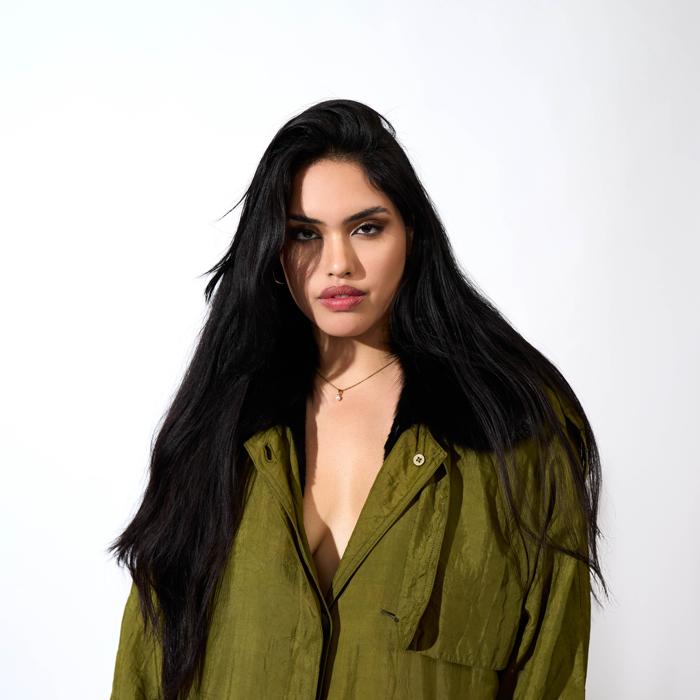 Close-up of Latinx female model in oversized green jacket photographed by Marty Gottlieb